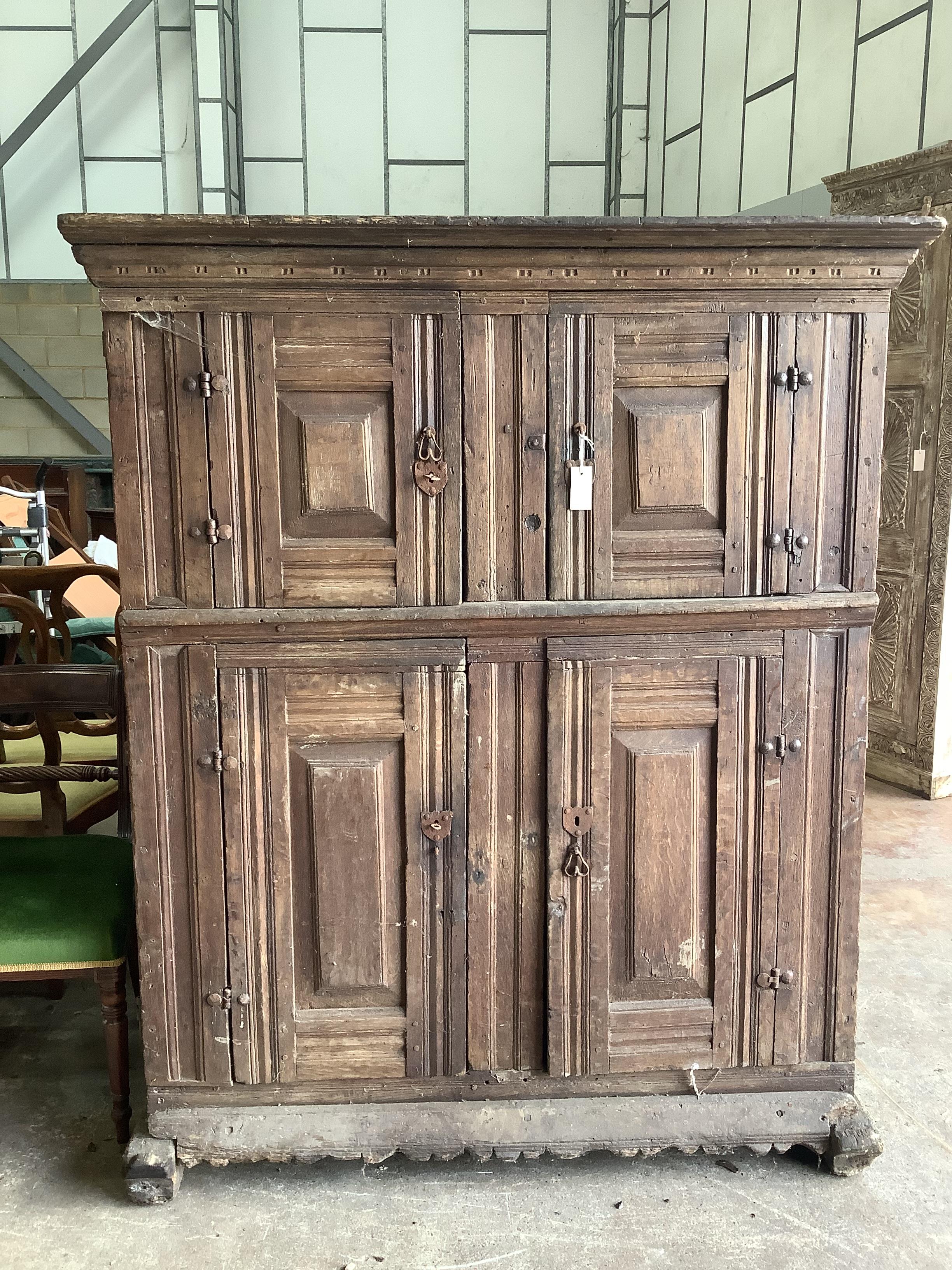 A Continental 17th century style oak four door hardwood cabinet, width 133cm, depth 60cm, height 162cm